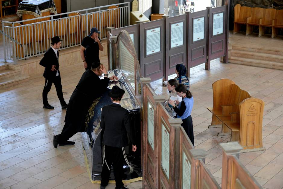 Worshippers gather on both sides of the Rambam’s tombstone